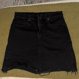 Black fitted denim skirt.